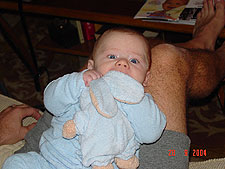 Sucking on his bear.