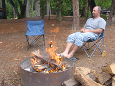 Ken relaxes by the fire.