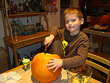 Hunter cleaning out a pumpkin