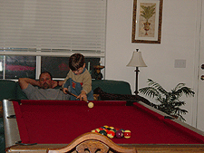 Ken and Tyler shoot pool.