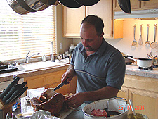 Ken carves the turkey.