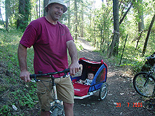 Hunter gets a ride from daddy in the bike trailer.