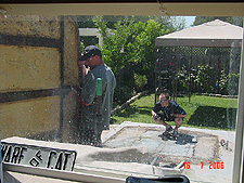 Scott helps the guys guide it onto the sidewalk.