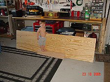 Hunter stands by the plywood.