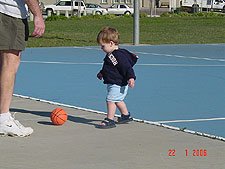 Hunter and daddy play with the basketball.