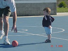 Hunter and daddy play with the basketball.