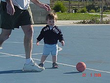 Hunter and daddy play with the basketball.