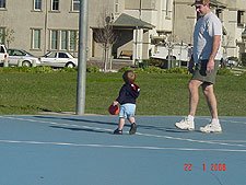 Hunter and daddy play with the basketball.