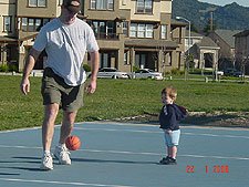 Hunter and daddy play with the basketball.