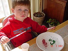 Hunter making pictures with glitter.