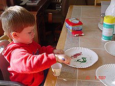 Hunter making pictures with glitter.