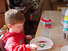 Hunter making pictures with glitter.
