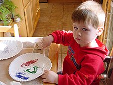 Hunter making pictures with glitter.