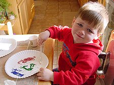 Hunter making pictures with glitter.