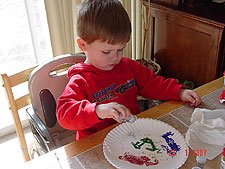 Hunter making pictures with glitter.