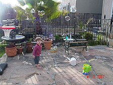 Hunter in the yard with the bubble blower.