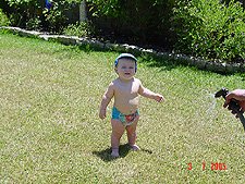 THunter getting sprayed with the hose.