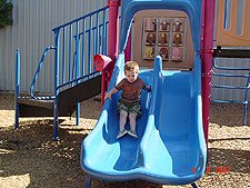 Hunter goes down the slide.