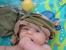 It's hard to dress a baby with his hand in his mouth.