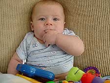 Sucking on his fingers again.