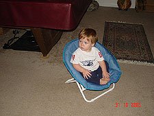 Hunter sat in his chair by the door to green the trick-or-treators.