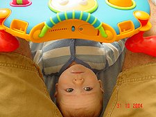 Hunter plays while Daddy holds his toy.