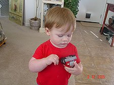 Hunter plays with his car.