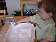 Hunter playing with snow