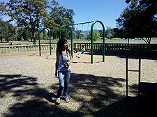 Heidi and Hunter in the background on the swings