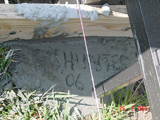Taking advantage of wet cement to write Hunter's name.