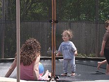 Ryder on the trampoline with mom and Hunter.