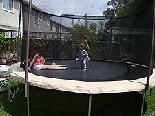 Ryder on the trampoline with mom and Hunter.