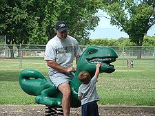 Hunter checks out the big teeth on this dinosaur.